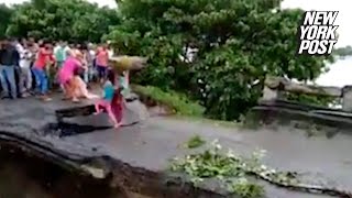 Desperate family swept away by floodwaters as bridge collapses  New York Post [upl. by Bores551]